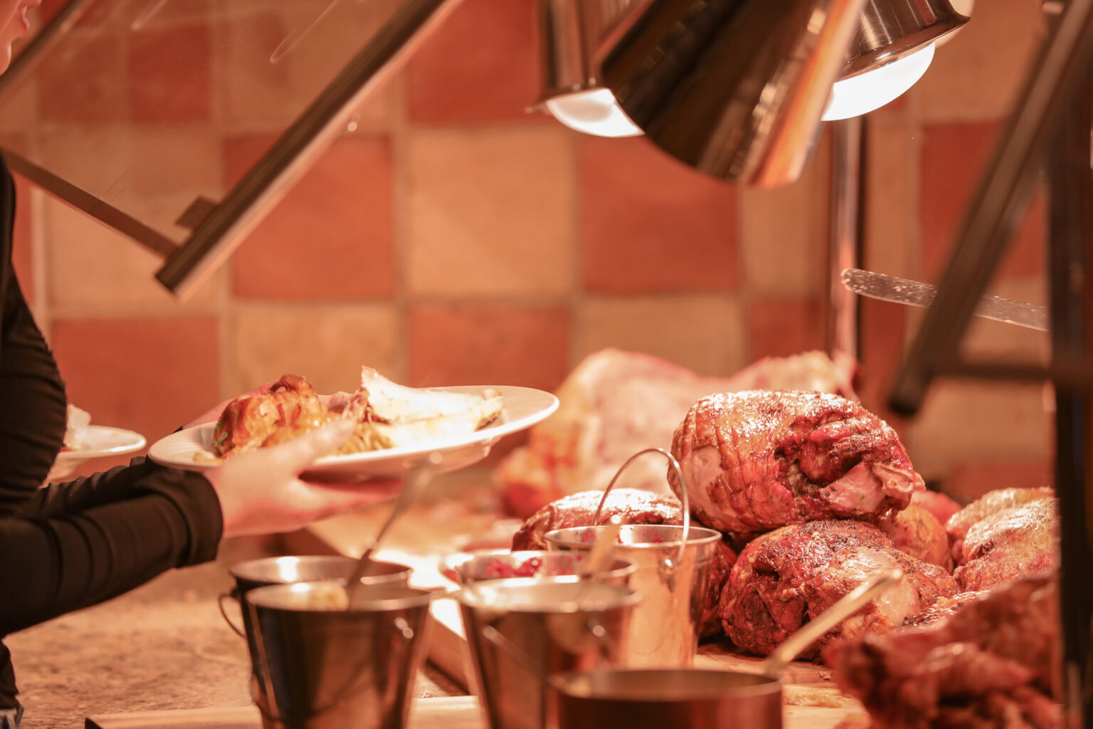 a-woman-holding-out-her-plate-at-a-buffet-line-la-2026-01-06-09-03-22-utc
